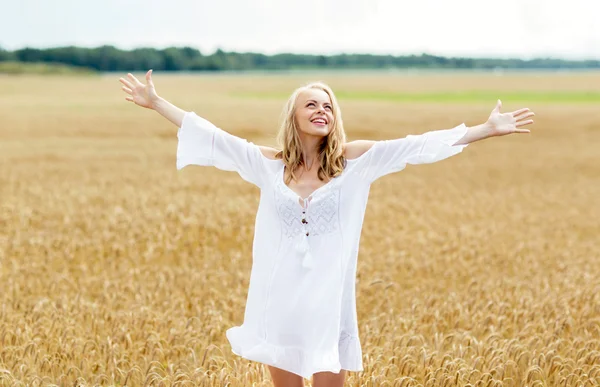 Smiling young woman in white dress on cereal field Royalty Free Stock Photos