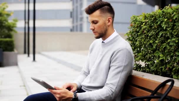 Man med TabletPC sittande på staden gatan bänk — Stockvideo