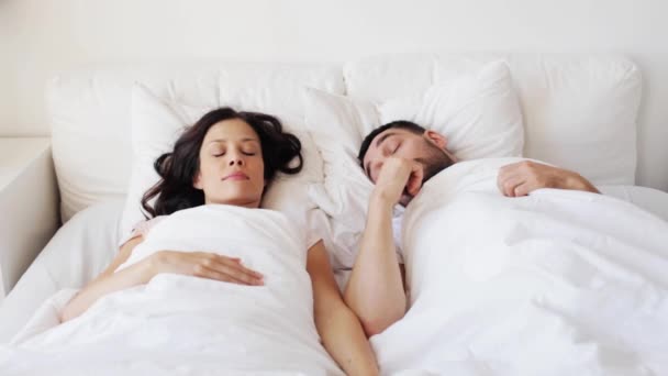 Feliz pareja despertando en la cama en casa — Vídeos de Stock