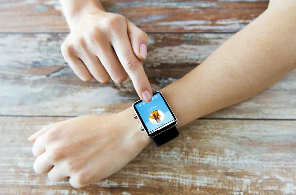 Close up of hands with music player on smart watch — Stock Photo, Image