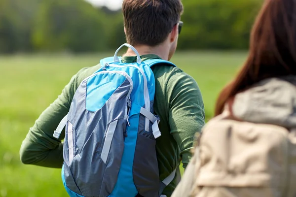 Close up of couple with backpacks hiking outdoors — Stock Photo, Image