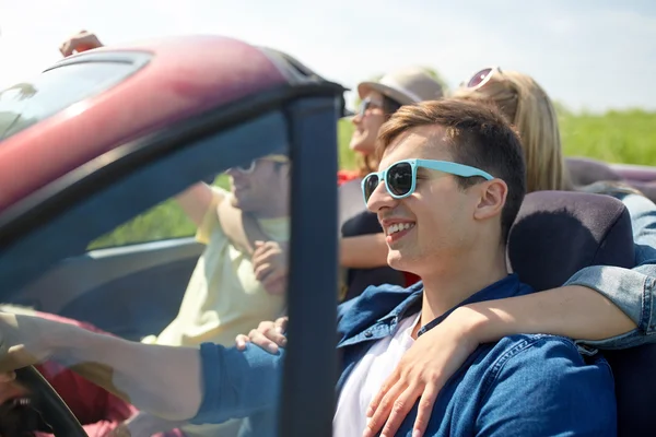 Щасливі друзі, що керують автомобілем в кабріолеті на дачі — стокове фото