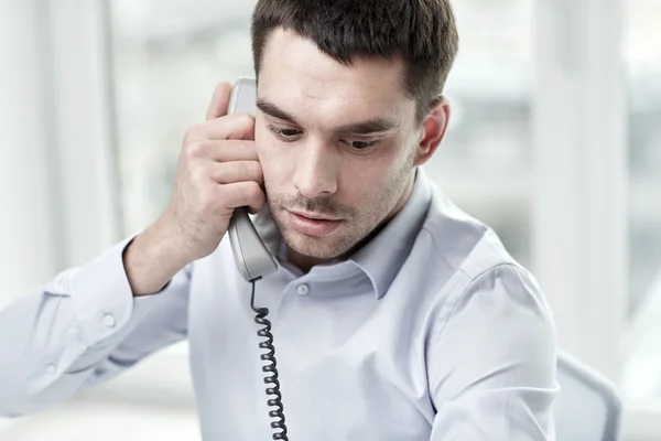 Face of businessman calling on phone in office — Stock Photo, Image