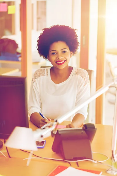 Businesswoman with computer and phone at office — Stock Photo, Image