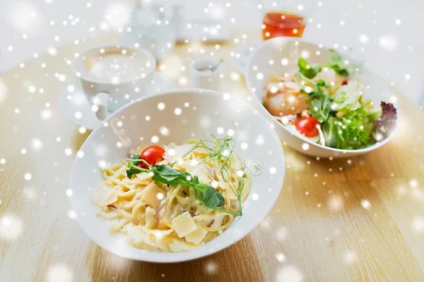 Close up of pasta in bowl on table at restaurant — Stock Photo, Image