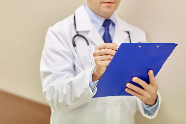 Close up of doctor with clipboard at hospital — Stock Photo, Image