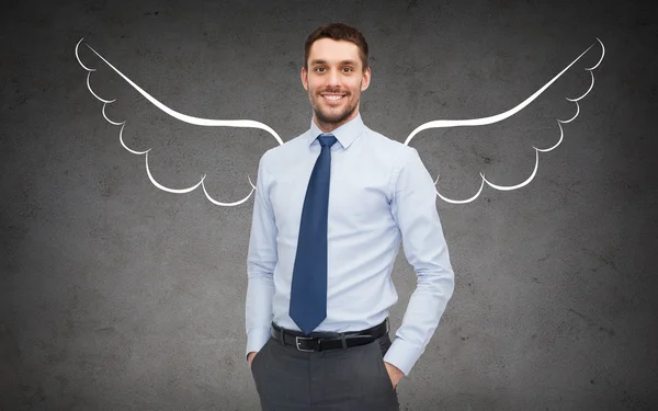 happy businessman with angel wings over gray