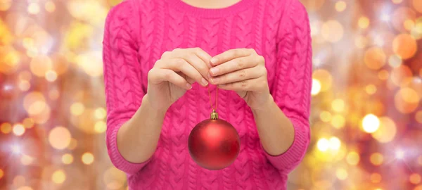 Close up van vrouw in trui met Kerstmis bal — Stockfoto