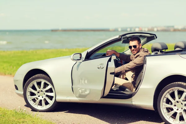 Glücklicher Mann öffnet Tür von Cabriolet-Auto im Freien — Stockfoto