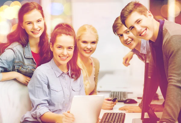 Students with computer monitor and tablet pc — Stock Photo, Image