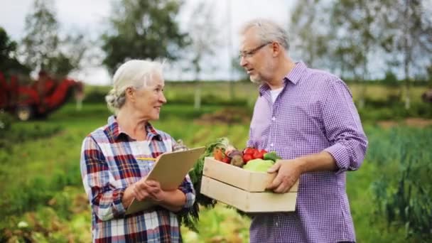 Casal sênior com caixa de legumes na fazenda — Vídeo de Stock