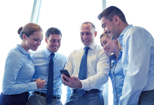 Happy businesspeople with smartphone — Stock Photo, Image