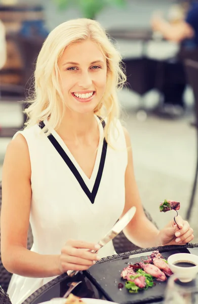 レストランのテラスで夕食を食べて幸せな女 — ストック写真