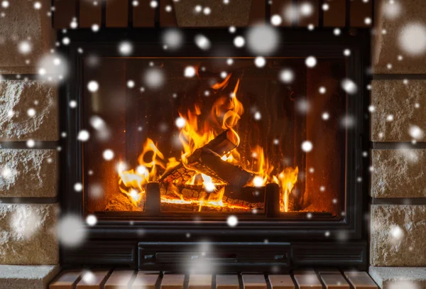 Close up of burning fireplace with snow — Stock Photo, Image