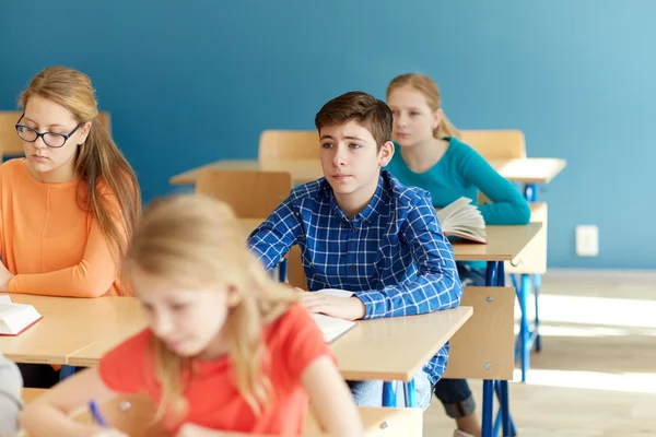 Grupo de alunos com cadernos na aula de escola — Fotografia de Stock