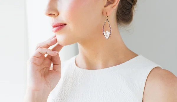 Close up of beautiful woman face with earring — Stock Photo, Image