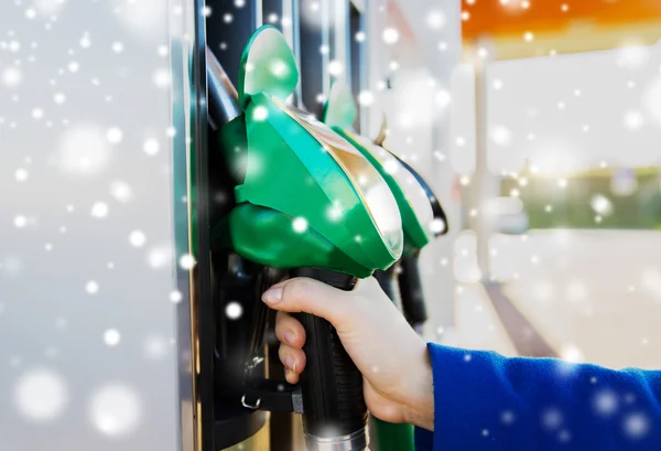 Close up of hand holding hose at gas station — Stock Photo, Image