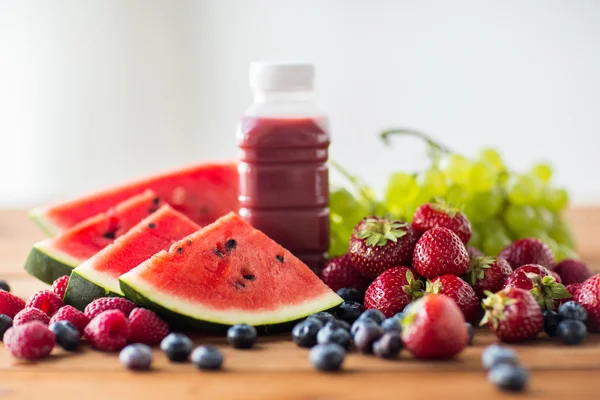 Бутылка с фруктовым и ягодным соком или смузи — стоковое фото