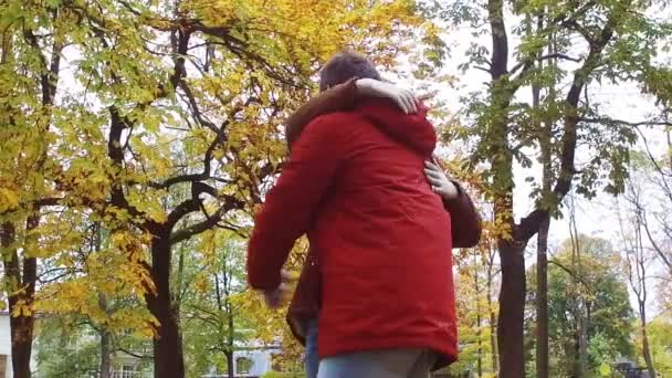 Feliz pareja joven abrazándose en el parque de otoño — Vídeo de stock