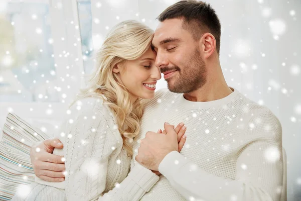 Casal feliz coberto com xadrez no sofá em casa — Fotografia de Stock