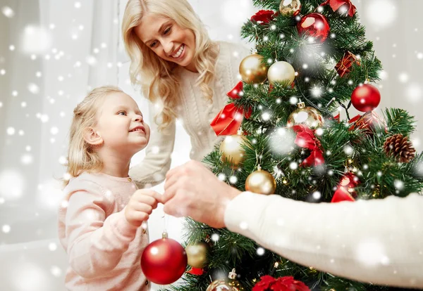 Glückliche Familie schmückt Weihnachtsbaum zu Hause — Stockfoto