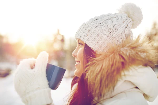 Happy young woman with tea cup outdoors in winter — Stock Photo, Image