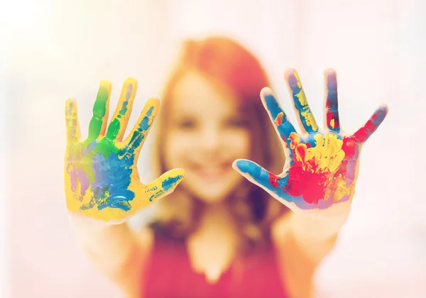 Happy girl showing painted hands — Stock Photo, Image