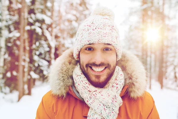 Jovem sorridente na floresta nevada de inverno — Fotografia de Stock