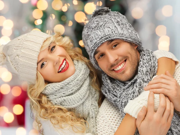 Happy family couple in winter clothes hugging — Stock Photo, Image