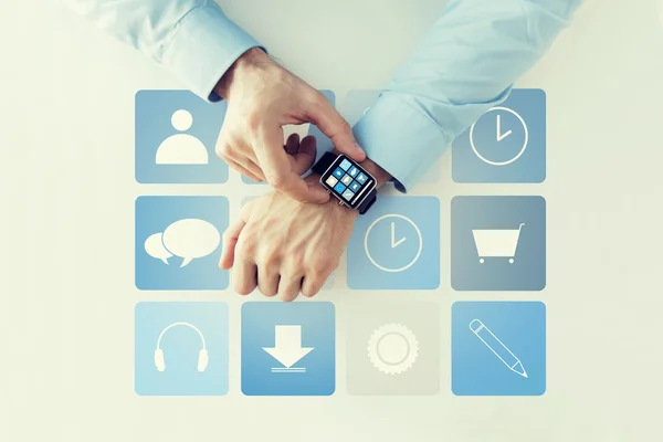 Hands with application icons on smart watch — Stock Photo, Image