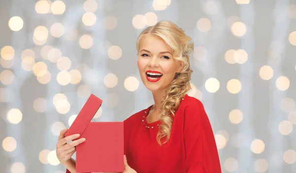 Happy smiling woman in red dress with gift box — Stock Photo, Image