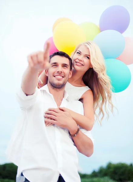 Par med färgglada ballonger till sjöss sida — Stockfoto