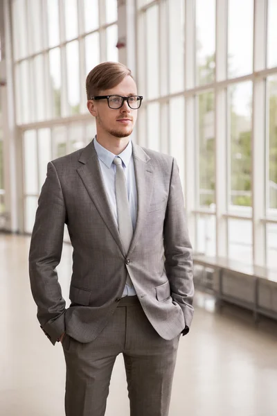 Young businessman in suit and glasses at office — Stock Photo, Image