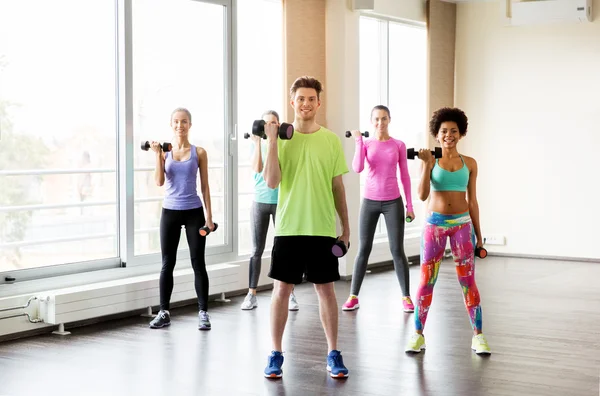 Groupe de personnes souriantes faisant de l'exercice avec haltères — Photo