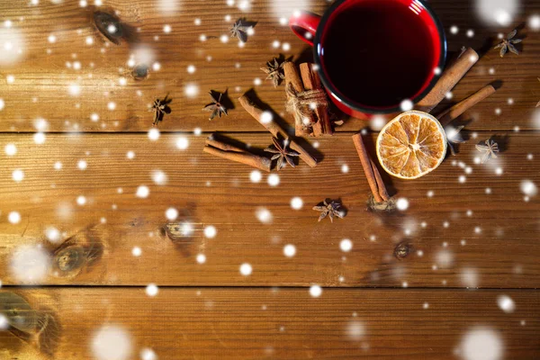 Tea cup with winter spices on wooden table — Stock Photo, Image