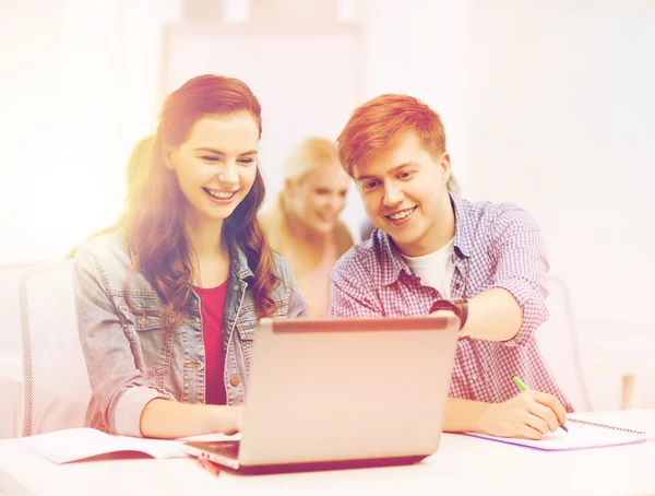 Students with laptop and notebooks at school — Stock Photo, Image