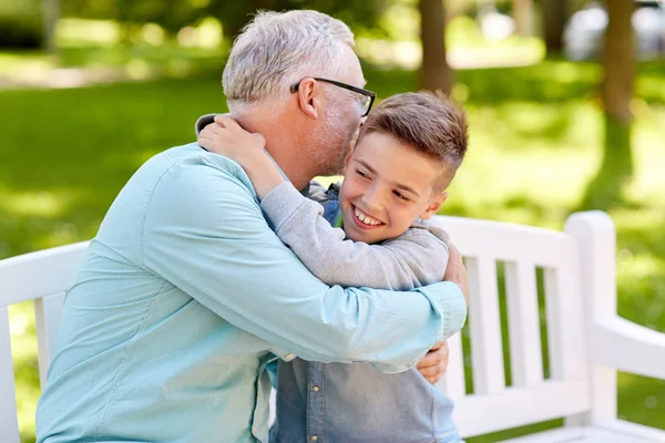 Grandfather and grandson hugging at summer park — Stock Photo, Image