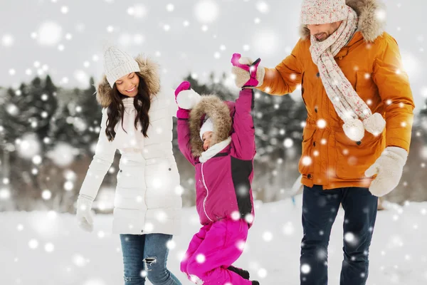 Happy family in winter clothes walking outdoors — Stock Photo, Image