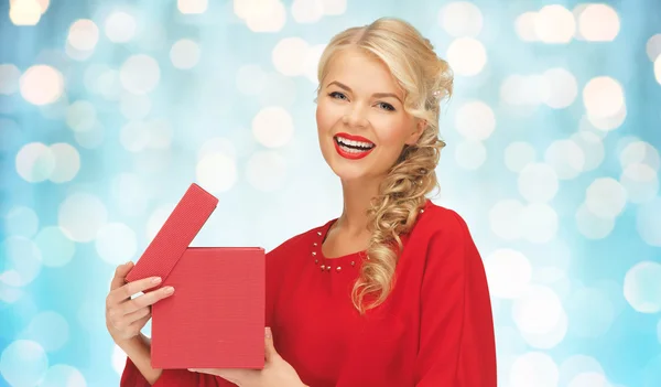 Happy smiling woman in red dress with gift box — Stock Photo, Image