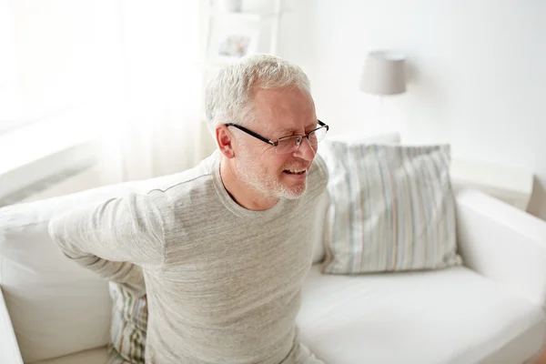 Unhappy senior man suffering from backache at home — Stock Photo, Image