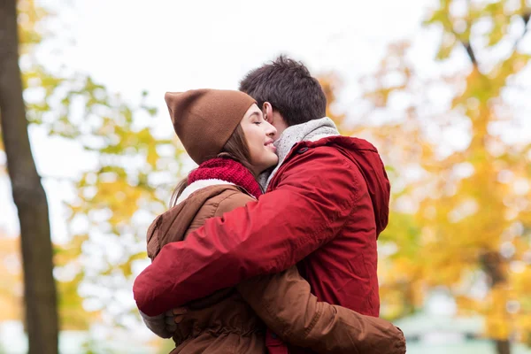 Glückliches junges Paar umarmt sich im Herbstpark — Stockfoto