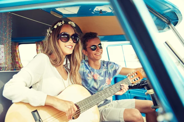 Sorrindo casal hippie com guitarra em minivan carro — Fotografia de Stock