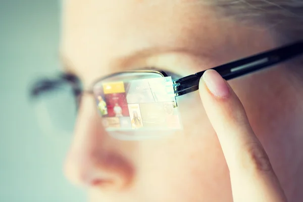 Close up of woman in glasses with virtual screen — Stock Photo, Image