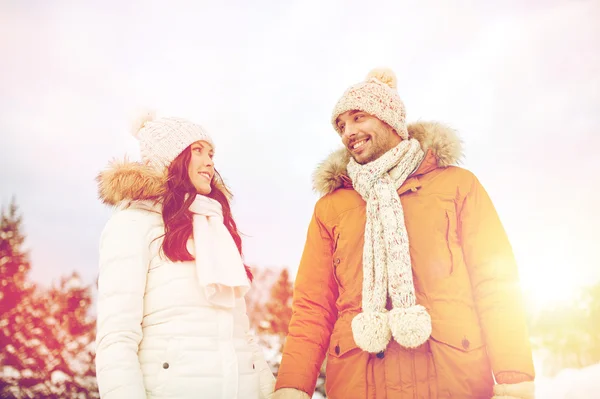 Happy couple walking over winter background — Stock Photo, Image