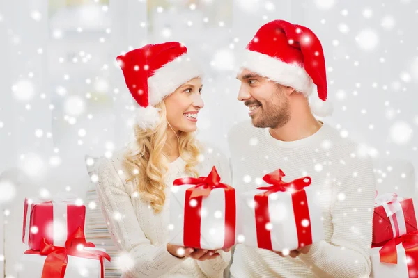 Feliz pareja en casa intercambiando regalos de Navidad —  Fotos de Stock