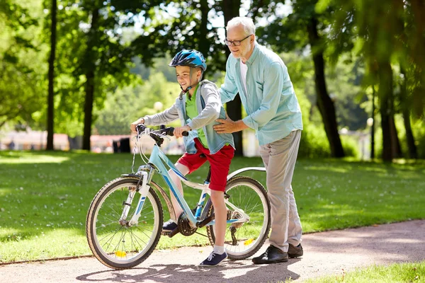 祖父和在夏天公园自行车的男孩 — 图库照片