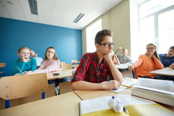 Klasgenoten lachen om student jongen op school — Stockfoto