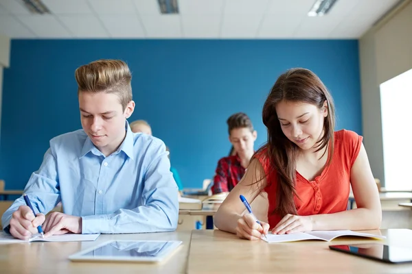 Group of students with books writing school test Royalty Free Stock Photos