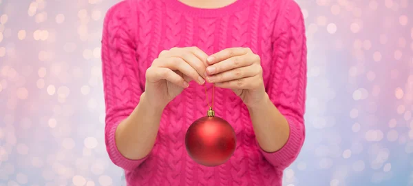 Close up of woman in sweater with christmas ball — Stock Photo, Image