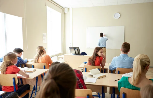 Studenter och lärare skriver om skolan whiteboard — Stockfoto